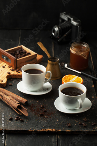 Cup of coffee, cinnamon and beans.