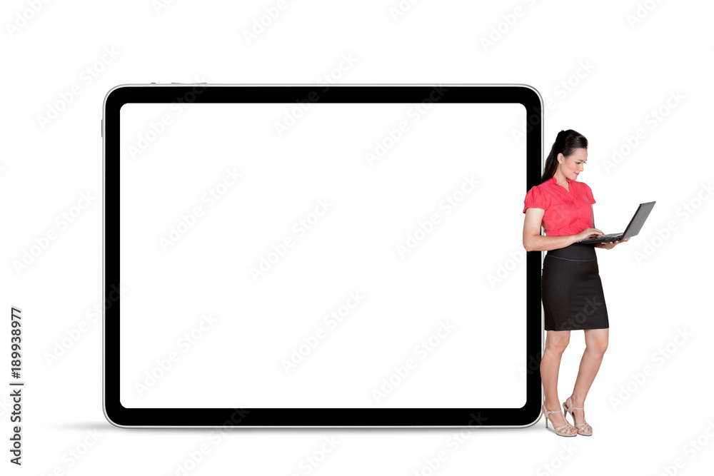 Female entrepreneur with laptop and tablet on studio Female entrepreneur with laptop and tablet on studio