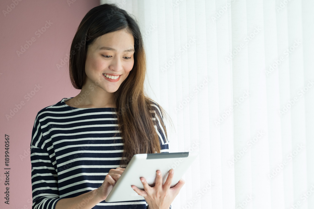 asian business owner wear casual cloth using tablet in home office working space for contact customer on online channel,office lifestyle with technology. asian business owner wear casual cloth using tablet in home office working space for contact customer on online channel,office lifestyle with technology.