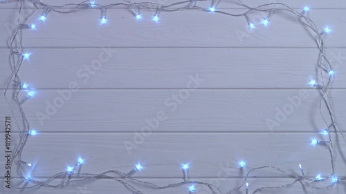 Mockup Snow white Christmas garland burns with bright colors. Top view photo