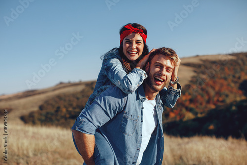 Happy young couple enjoys a sunny day in nature