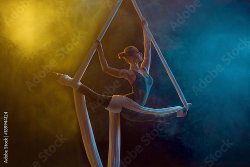 Graceful gymnast performing aerial exercise