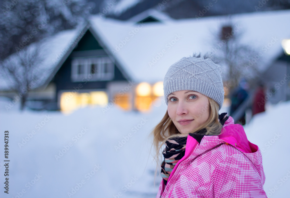 woman wearing winter outfit posing in winter village in austria