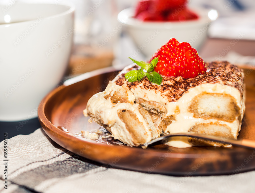 Homemade tiramisu cake decorated with strawberries Italian cuisine, Selective focus Homemade tiramisu cake decorated with strawberries Italian cuisine, Selective focus