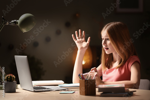 Teenage girl with laptop do...