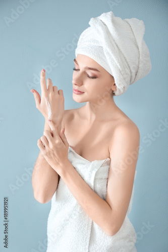 Young woman applying hand c...