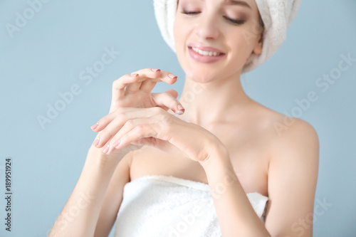 Young woman applying hand c...