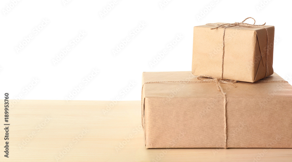 Parcel gift boxes on table against white background Parcel gift boxes on table against white background