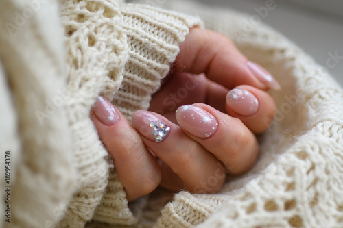 Nail Polish. Art Manicure. Modern style blue Nail Polish.Stylish pastel Color pink white Nails holding wool material sleeve blouse isolated white background wall. Classic wedding bride nails design