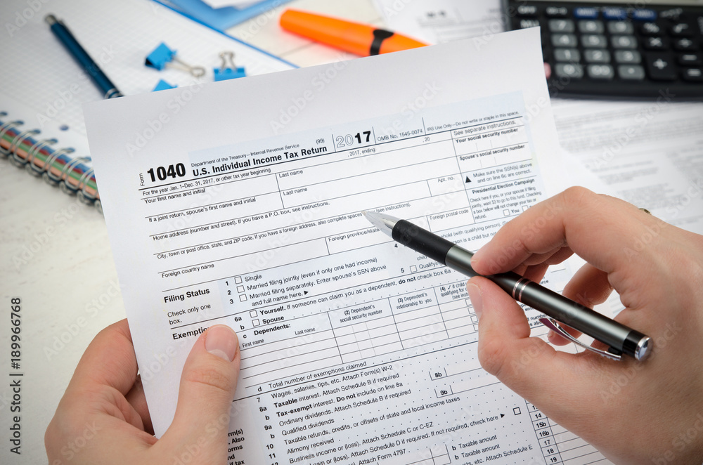 Man filling US tax form. Man filling US tax form.