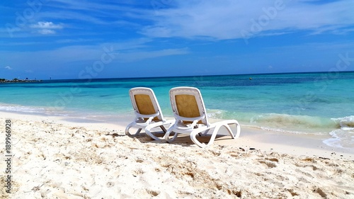 Beach chairs isolated blue waters