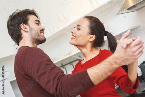 Young couple having romantic evening at home in the kitchen dancing close-up