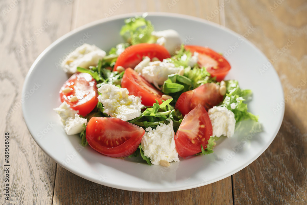 Fresh summer salad with tomatoes, arugula and mozzarella Fresh summer salad with tomatoes, arugula and mozzarella