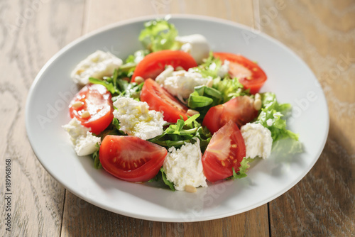 Fresh summer salad with tomatoes, arugula and mozzarella