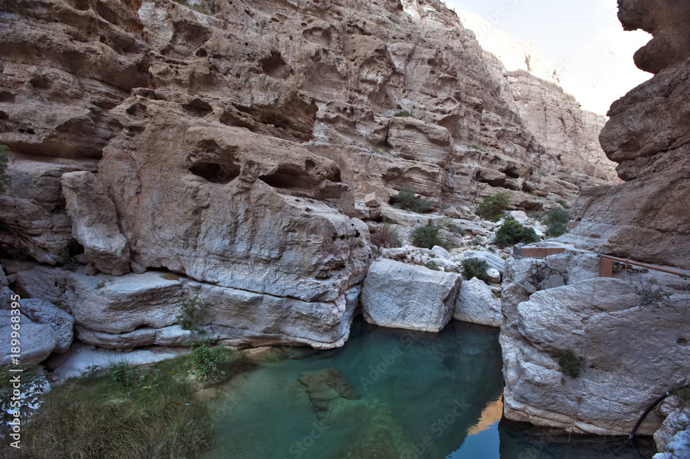 The stone in the shape of a monkey's head. Beautiful Eastern landscape. Wadi Bani Khalid. Wadi Shab. Oman.