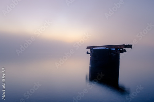 Old brooken jetty in mist photo