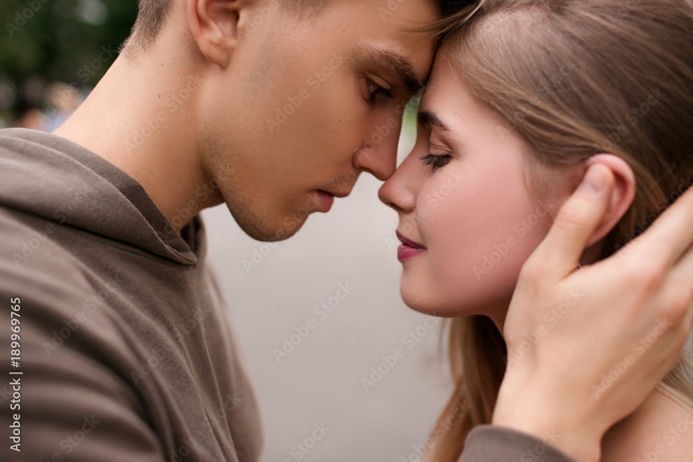 couple in love walking in the park. street romance. tenderness and care couple in love walking in the park. street romance. tenderness and care
