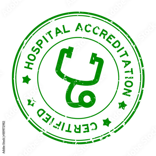 Grunge green hosptial accreditation with stethoscope icon round rubber seal stamp on white background photo