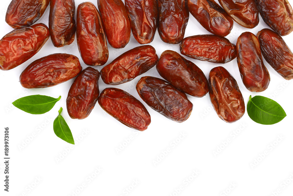 dry dates with green leaves isolated on white background with copy space for your text. Top view. Flat lay pattern dry dates with green leaves isolated on white background with copy space for your text. Top view. Flat lay pattern