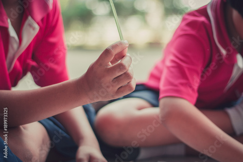 Closeup to hand of Thai students grade 4 in primary school are weaving pattern thai.