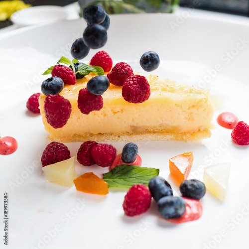 dessert cheesecake berries decoration concept. lifestyle of confectioner. creation process.