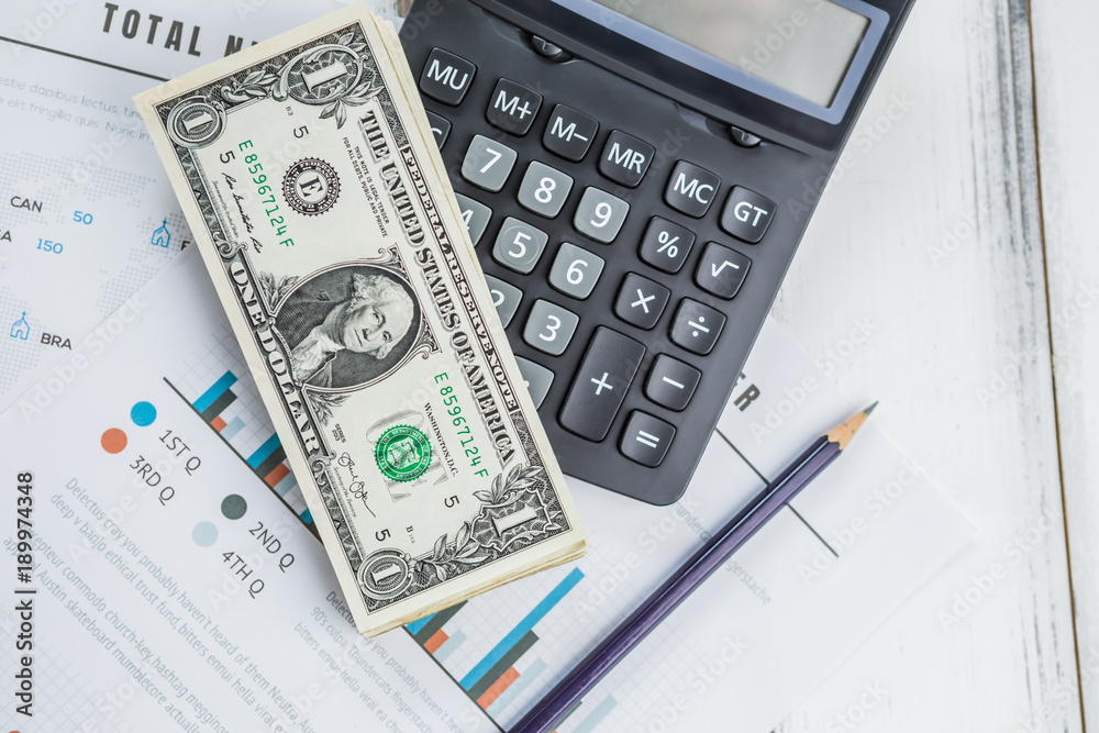 Calculator with american dollars on the wooden table background, finance concept Calculator with american dollars on the wooden table background, finance concept