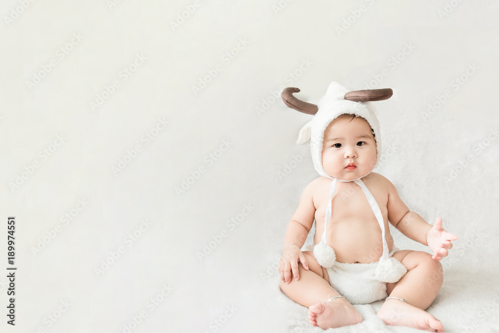 Soft focus Cute Asian male baby sitting on a towel. Blurred background. Soft focus Cute Asian male baby sitting on a towel. Blurred background.