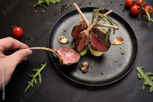 tasting delicious gourmet rack of lamb recipe concept. meat restaurant meal. luxury lifestyle.