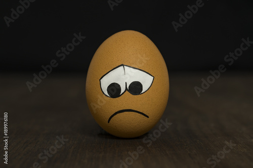 Egg with a sad smiley.