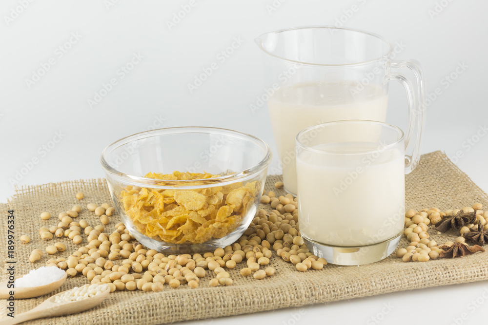 Soy milk in glass and sereal ,garnish in wooden spoon.
