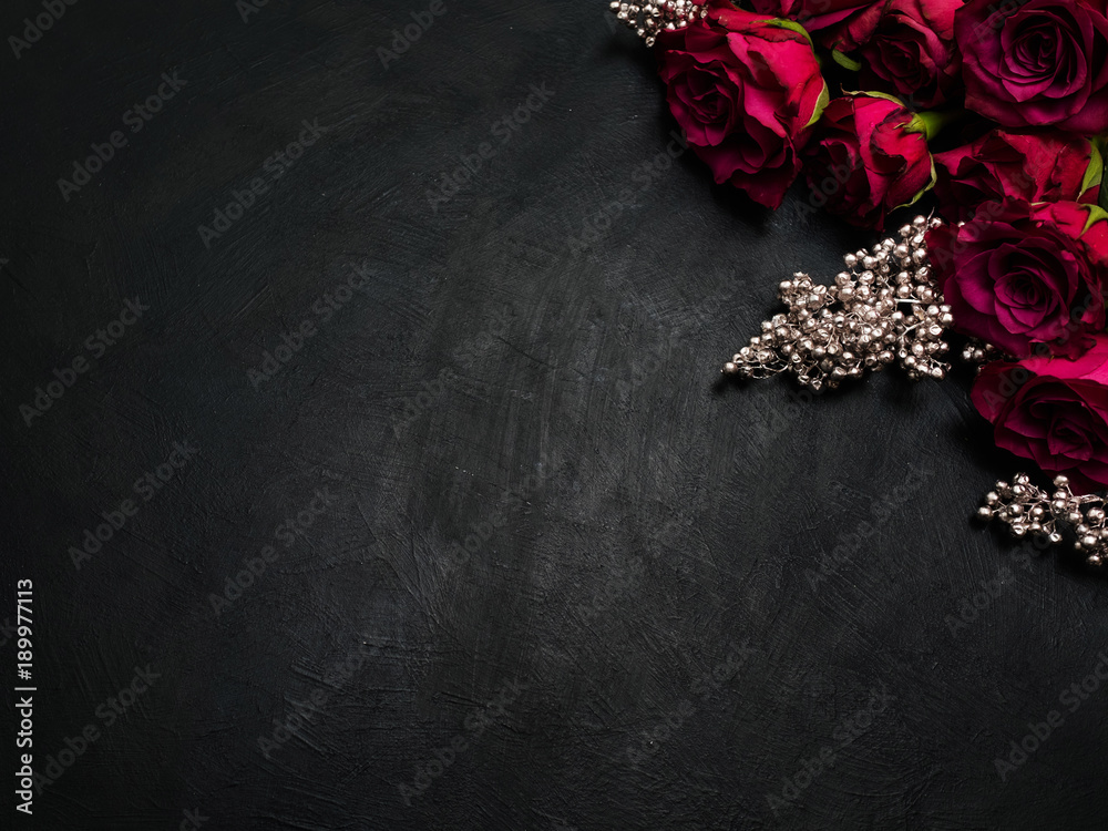 Burgundy or wine red roses and silver decor on dark background. True love passion and desire. Copy space concept Burgundy or wine red roses and silver decor on dark background. True love passion and desire. Copy space concept