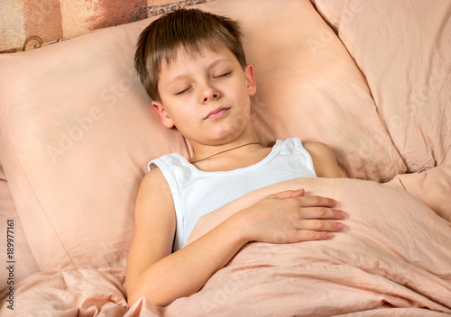 Boy sleeping in bed
