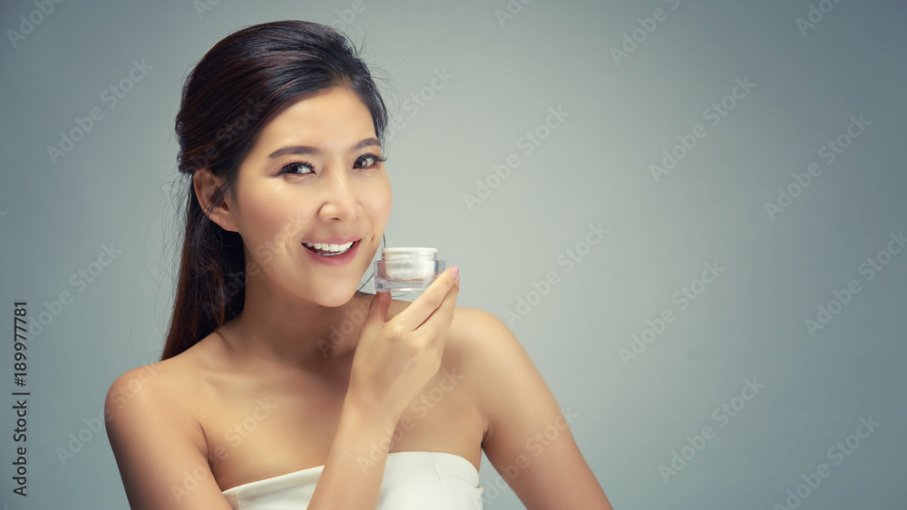 Happy beautiful asian girl with the fresh skin in grey colour background. Expressive facial expressions. Cosmetology and Spa concept. Happy beautiful asian girl with the fresh skin in grey colour background. Expressive facial expressions. Cosmetology and Spa concept.