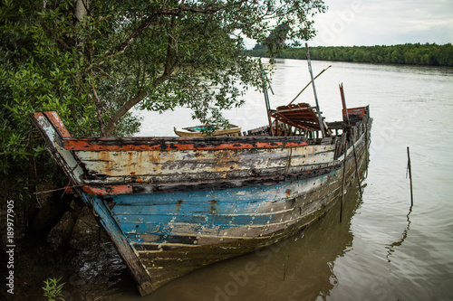 The ship was destroyed Old wooden boats were destroyed by the waves on the sand.