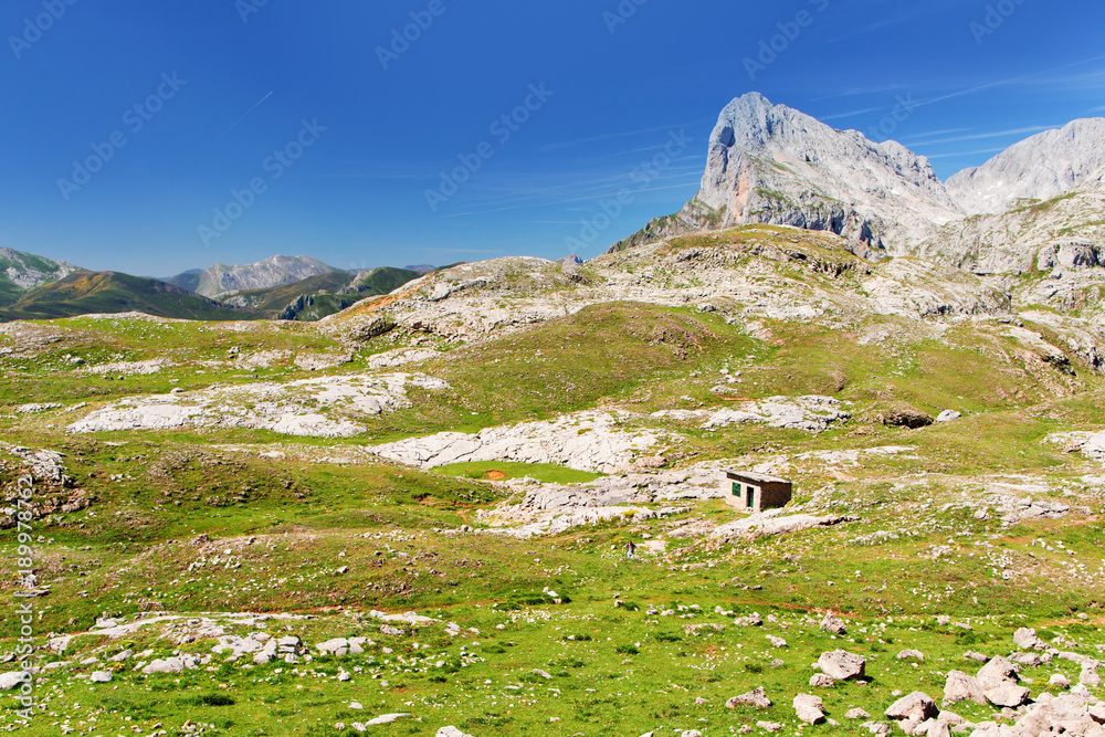Stony track in mountains of Picos de Europa and tourists, the vicinity of Fuente De Stony track in mountains of Picos de Europa and tourists, the vicinity of Fuente De