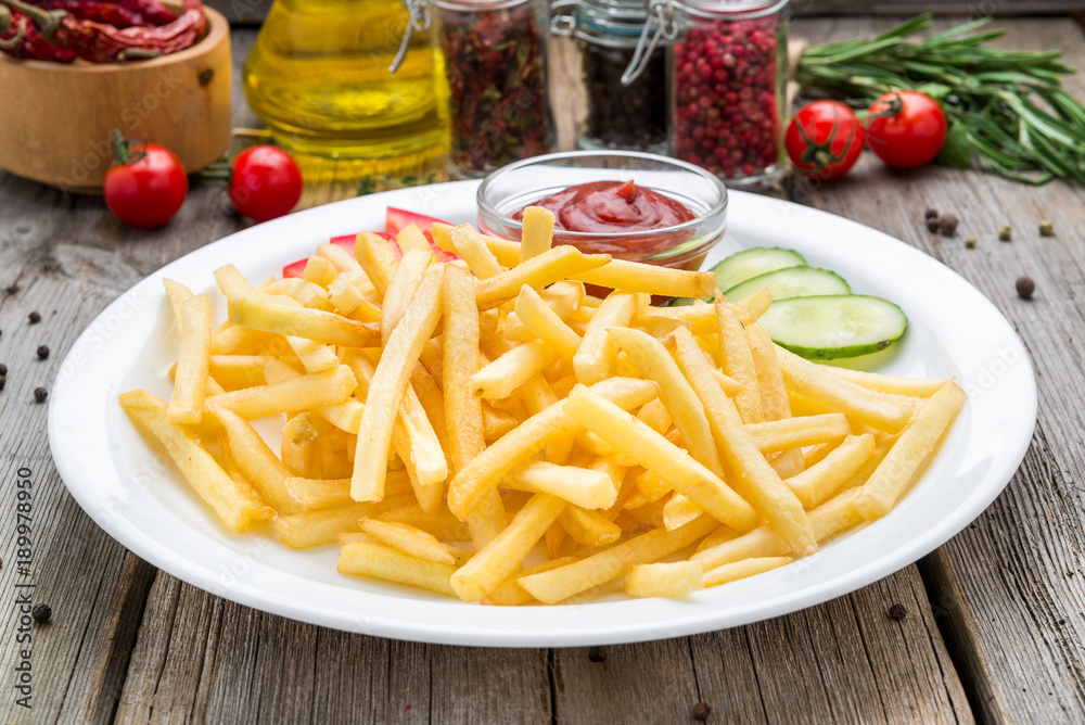 Tasty french fries on cutting board Tasty french fries on cutting board