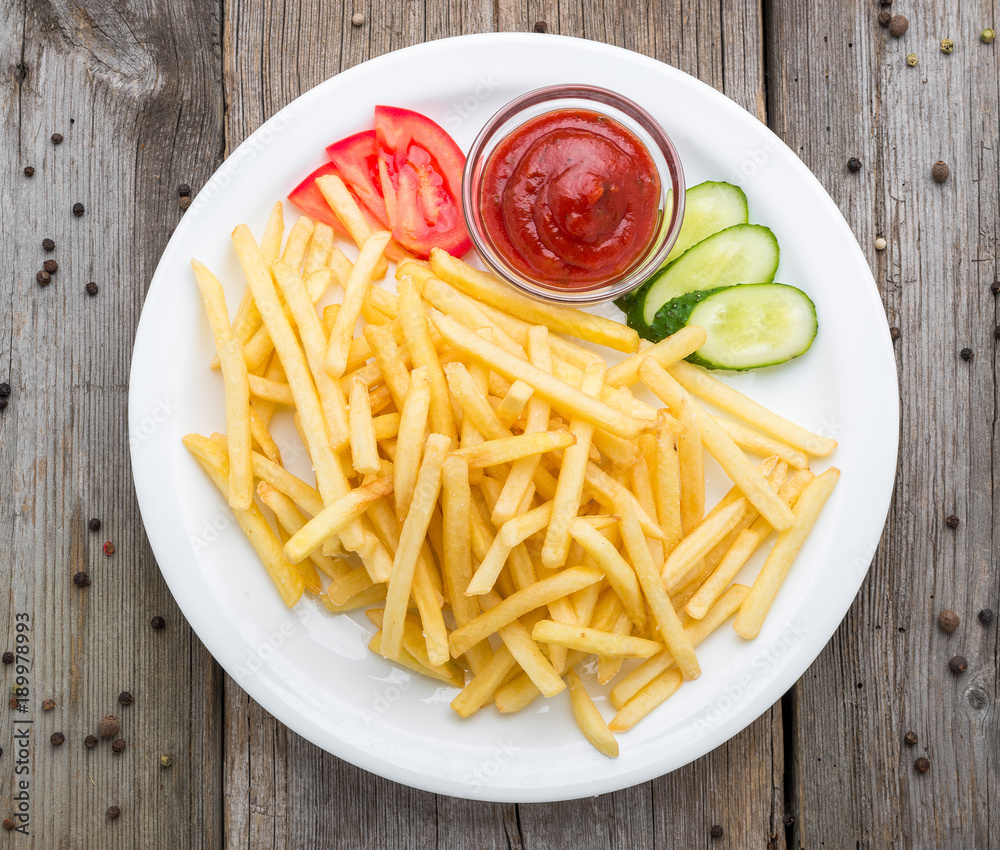 Tasty french fries on cutting board