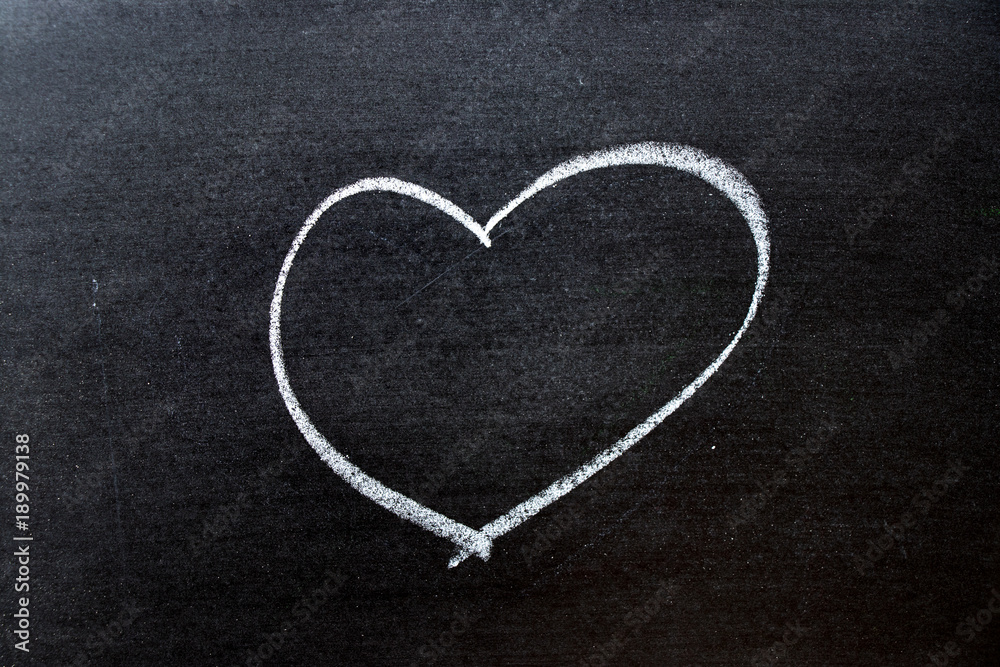 White coloe chalk drawing as heart shape on blackboard background with copy space White coloe chalk drawing as heart shape on blackboard background with copy space