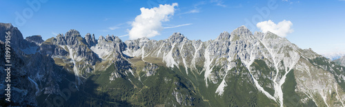 Panorama of an old mountain range with tree line in Europe. The run off erosion patterns are shown clearly. 