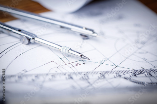 Fotografi Architectural blueprints and blueprint rolls and a drawing instruments on the worktable