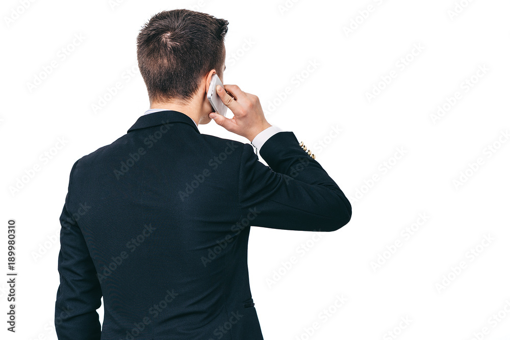 Back view of young business mmman talking on the phone, isolated, copy space Back view of young business mmman talking on the phone, isolated, copy space
