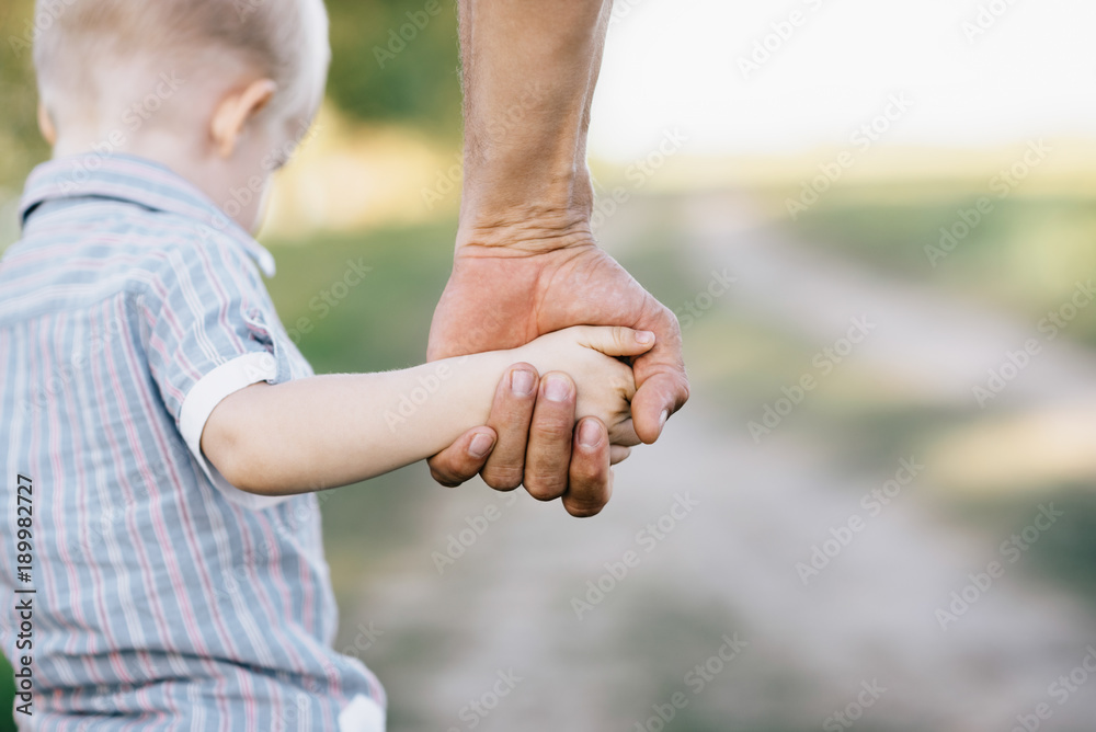 © zahar2000 - the father holds the son by a hand outdoors © zahar2000 - the father holds the son by a hand outdoors