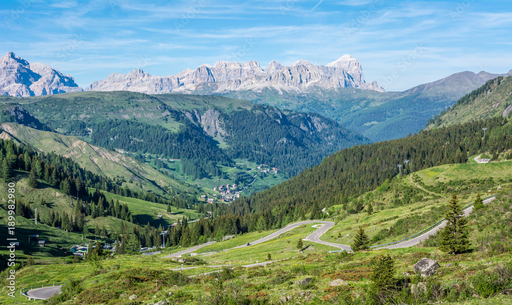 mountain landscape in summer in Trentino Alto Adige. View from Passo Rolle, Italian Dolomites, Trento, Italy. Mountain road - serpentine in the mountains Dolomites, Italy