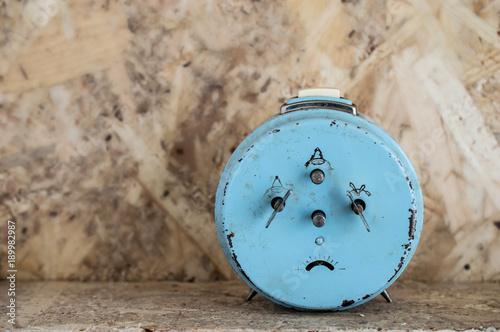 Blue Vintege clock making sade face photo
