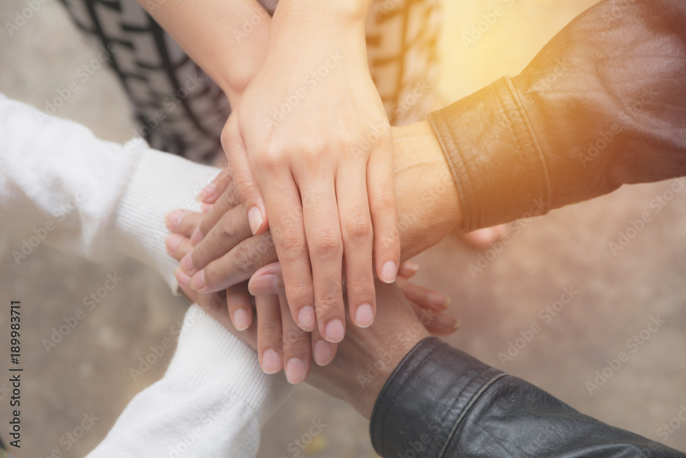 Close up of people putting their hands together. Stack of hands unity and teamwork concept. Close up of people putting their hands together. Stack of hands unity and teamwork concept.