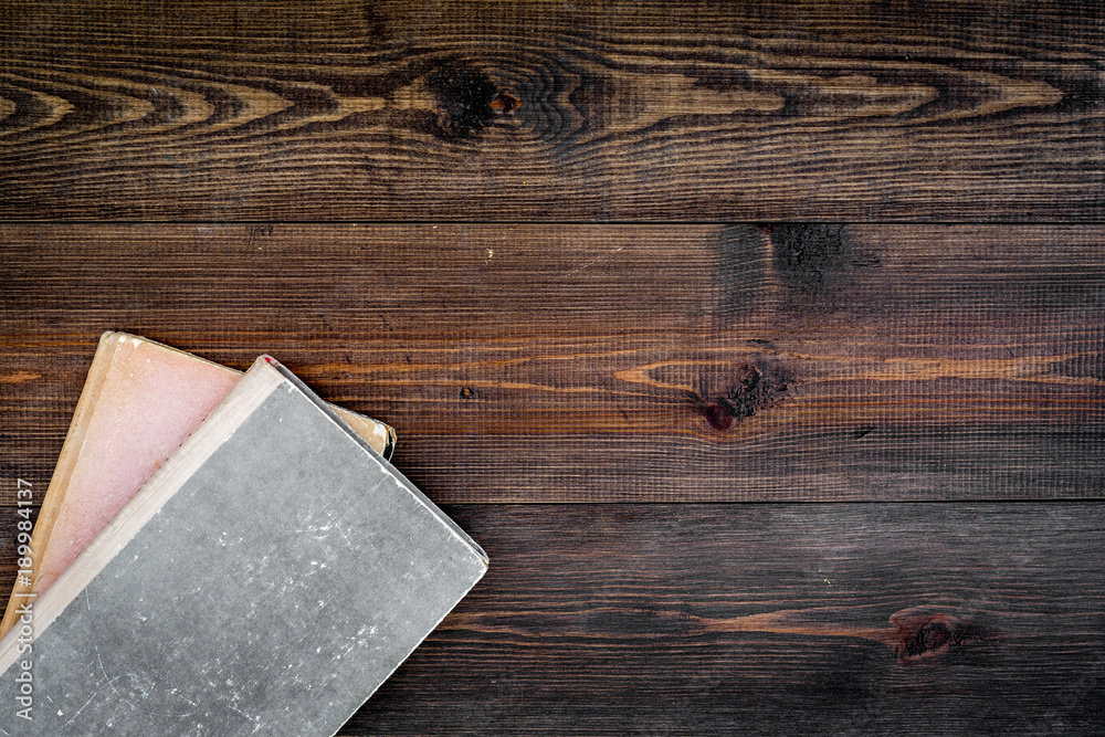Reading and self-development. Old book on dark wooden background top view copy space Reading and self-development. Old book on dark wooden background top view copy space
