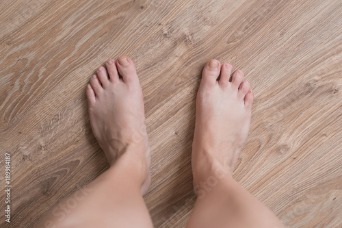 wooman feet on the wooden floor