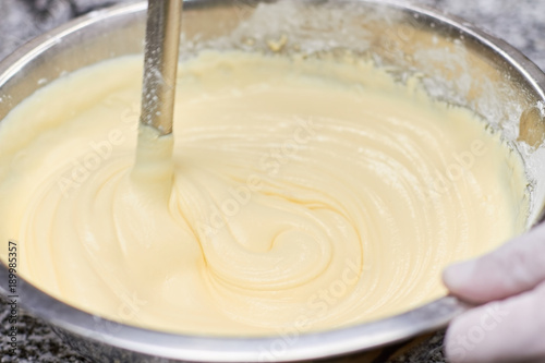 Obraz na plátně Stirring batter in bowl, close up
