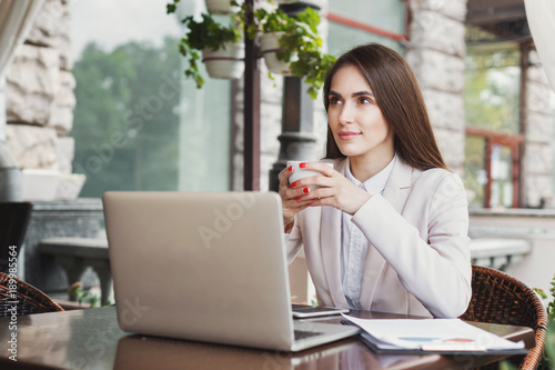 Young businesswoman outdoors working with laptop