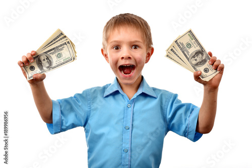The boy is a businessman. A man holds dollars. The boy has money in his hand. Good profit. The offer for a child. The pocket expenses.